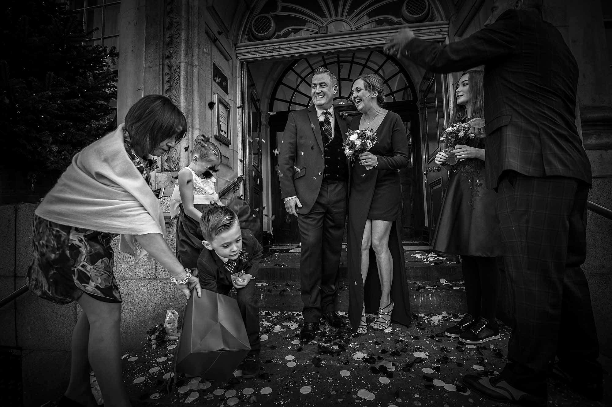 Kensington and Chelsea Register Office Wedding Confetti on Step - Boy Reaching in Bag